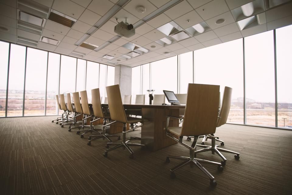 A clean, empty meeting room with a long table