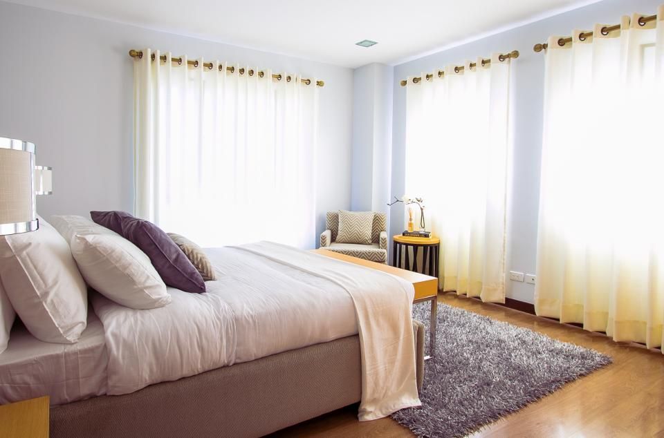 A made bed in a bright bedroom